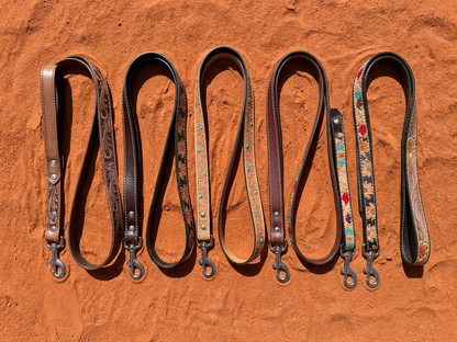 Five Western Soul leather dog leashes laid out with loop handles and metal clips