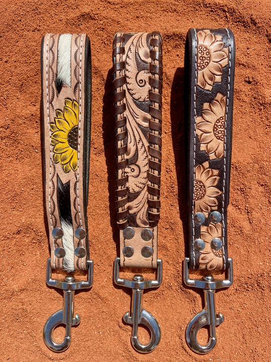 Three Western leather traffic leads with silver clasps: Sunflower Cowhide, Western Scroll and Desert Sunflower styles, left to right